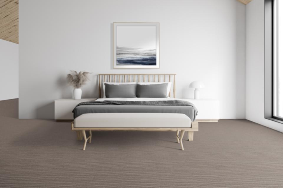 patterned carpet in bedroom with light wood and white furniture.